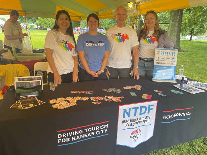 employees wearing pride shirts working the NTDF booth