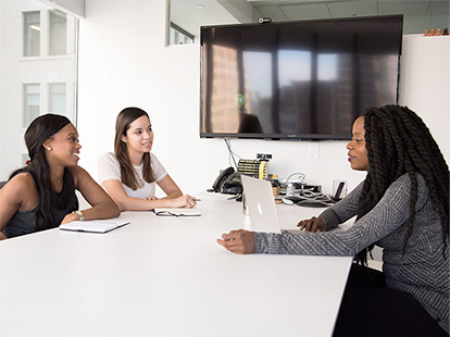 women around a table at a resource fair