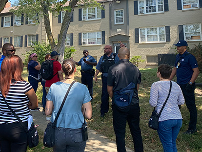 police taking to people outside a dwelling