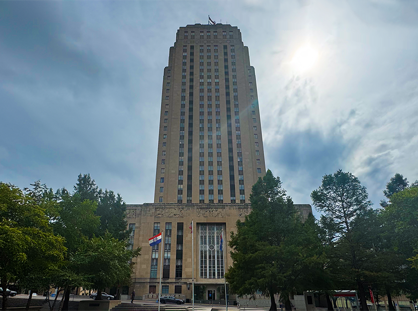 City Hall with the sun peaking through the clouds