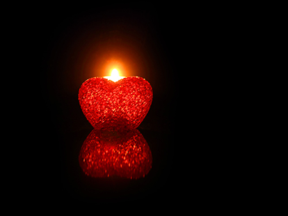 heart shaped candle lit