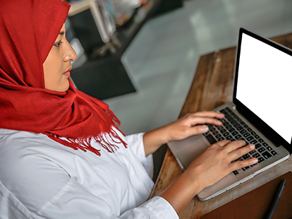 resident typing on a laptop