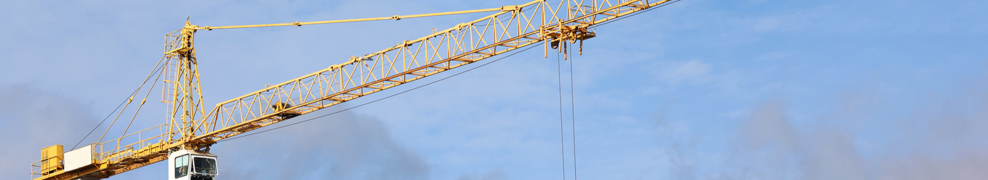 Large construction crane with blue sky in the background