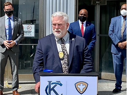 Dr. Rex Archer speaking behind a podium