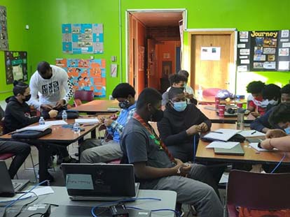 properly masked children learning in a classroom